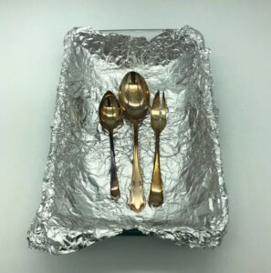 Tarnished silver cutlery prepared for Eco-Alternative Silver Dip