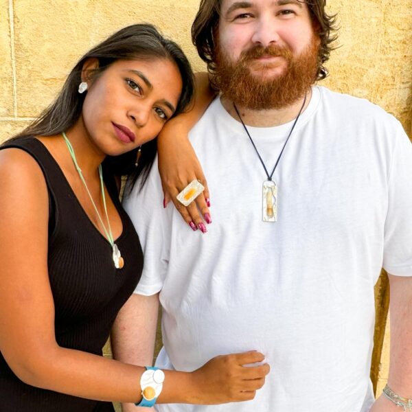 Stalactite-couple wearing ring bracelet and dangling earrings