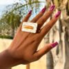 Stalactite-two fingered ring worn by woman